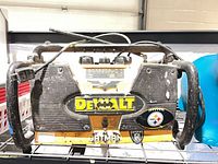 Front view showing DeWalt radio, stickers, speaker grilles and roll cage