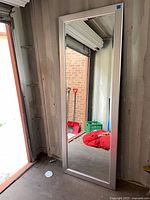 Front view of silver framed full-length mirror