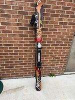 Full view of strapped pair of Head skis with bindings