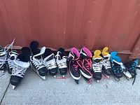 Eight pairs hockey skates lined up
