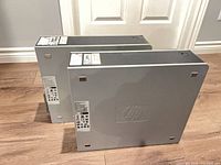 Two HP Compaq SFF desktops side view showing silver top panels