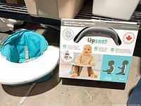 Upseat boxed seat beside Summer Infant seat