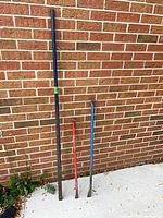 All three pry bars leaning against brick wall