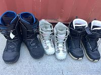 All three pairs of snowboard boots lined up side by side