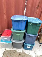 stack of eight plastic totes showing variety of colors and lids
