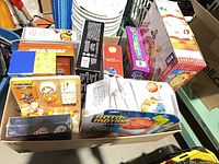 Box containing assorted children’s craft kits, puzzles and games