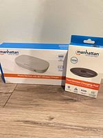 Front view of both boxed Manhattan products