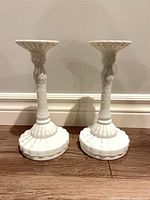 Both milk glass candlesticks front view showing shape and bases