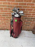 Full view of maroon carry bag filled with irons