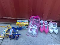 Group shot of all six skate pairs: strap-on skates, boxed BOB skates, three molded pairs
