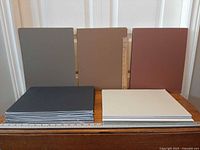 Assorted color matboard stacks and upright boards with ruler for scale