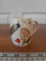 Humpty Dumpty side with Brixham Pottery label and red flower