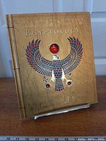 Front cover showing gilt Horus hawk with red gem