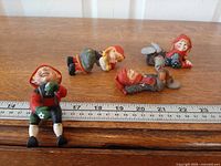 All four Candy Designs figurines with ruler for scale