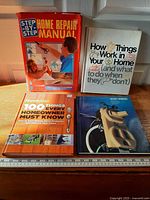 All four hardcover home maintenance books displayed together with covers visible