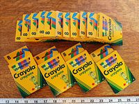 Front view of fourteen 8-count Crayola crayon boxes aligned in two rows