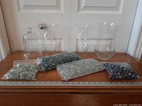 All glass vessels and four bags of vase filler displayed