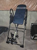 Angled left-front view showing backrest, frame, and ankle locking mechanism