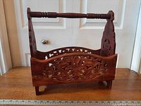 Front view showing floral fretwork and turned handle