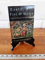 Front cover of softcover book on stand