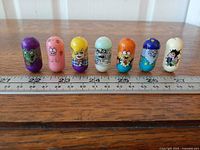 All seven Mighty Beanz lined up on ruler for scale