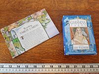 Boxed tarot deck and instruction leaflet next to ruler