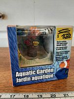 Front of sealed box showing Aquatic Garden unit and fish figures