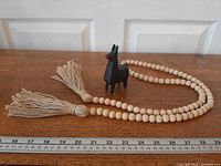 Garland and figurine with ruler for scale