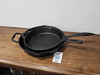 Both cast iron skillets stacked