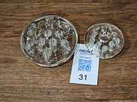 Both glass flower frogs side by side with size reference