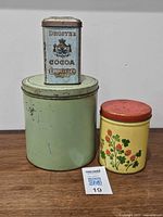 All three tins grouped together on wood surface