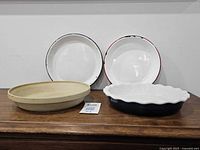 All four pie plates lined up on surface