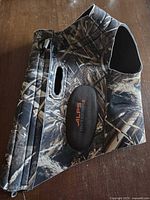 Full view of camouflage ALPS OutdoorZ neoprene dog vest with logo patch and zipper