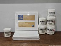 All canvas panel packs and Golden Gel Mediums jars grouped on shelf