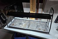 Full view of Floralight grow light on table showing frame, hood and trays
