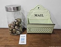 Glass jar with jingle bells and metal mail basket