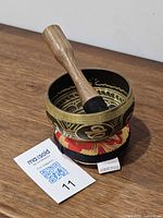 Singing bowl on cushion with striker beside, showing overall set