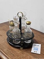 Full cruet set on stand showing all four bottles and stand