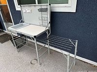 Camp kitchen fully assembled showing main counter, wash tub, side stove table and lower shelf