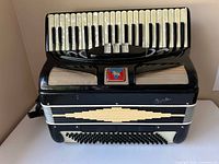 Front view showing 41 keys, grille, emblem