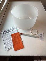 Top view of bowl with mallet, stand, instructions