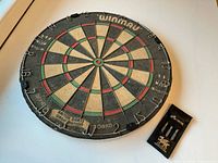 Front view of Winmau dartboard showing face, wiring, number ring and brand markings