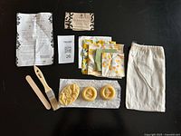 Complete contents laid out: instructions, wax blocks, fabrics, brush, stick, bag
