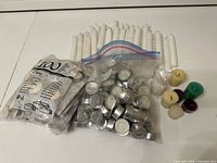 Group of tealight bags, colored votives and white tapers on table