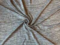 Fabric spread out showing color and stripe pattern