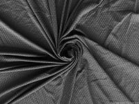Full piece of black textured fabric spread out, showing shell pattern