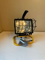 Front view showing flood light, stand, wire guard, and info tag