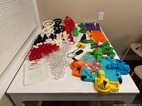 All components laid out: marble run pieces, Hungry Hippos game, marbles, instruction sheet