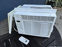 Front, top and inserts of air conditioner plus remote