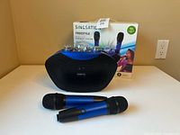 Speaker unit, two microphones, retail box visible